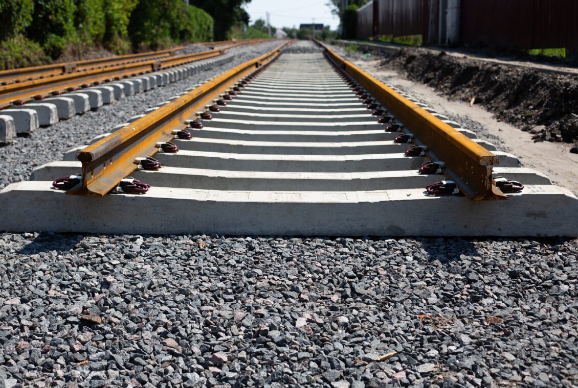 Railroad tracks under construction with gravel.
