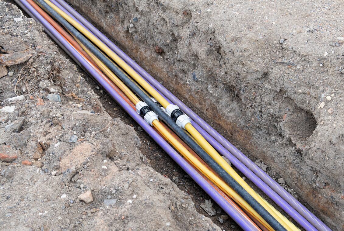 Colorful cables in a trench underground.